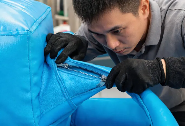 Technician inspecting soft-play padding seam